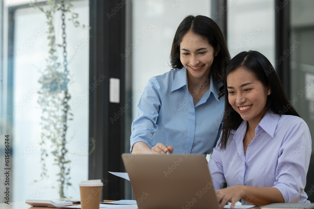 Two Asian business women Discussing new startup projects Financial reports, project presentations, analytical concepts, planning and financial statistics and investment markets at the office. Two Asian business women Discussing new startup projects Financial reports, project presentations, analytical concepts, planning and financial statistics and investment markets at the office.