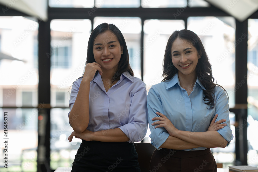 Two Asian business women Discussing new startup projects Financial reports, project presentations, analytical concepts, planning and financial statistics and investment markets at the office. Two Asian business women Discussing new startup projects Financial reports, project presentations, analytical concepts, planning and financial statistics and investment markets at the office.
