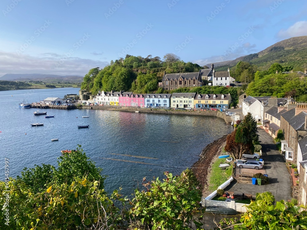 A spectacular view looking down on the town of Portree with it's colorful homes, on the Isle of Skye on a sunny blue sky summer day in the highlands of Scotland