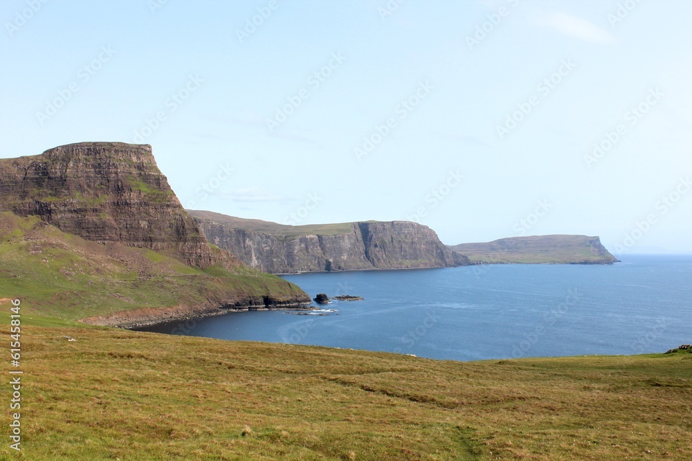 A spectacular view of the Isle of Skye and its rugged coastline of cliffs on a sunny blue sky summer day