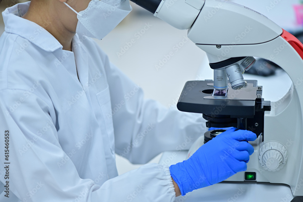 Medical Science Laboratory: Portrait of a scientist looking under a microscope without analyzing a test sample. Ambitious young biotechnologist working with advanced equipment. Medical Science Laboratory: Portrait of a scientist looking under a microscope without analyzing a test sample. Ambitious young biotechnologist working with advanced equipment.