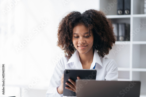 Happy black businesswoman using a smartphone play social in a creative office.