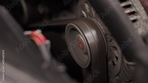 Belt spinning on a wheel, car engine belt, timing belt cog
