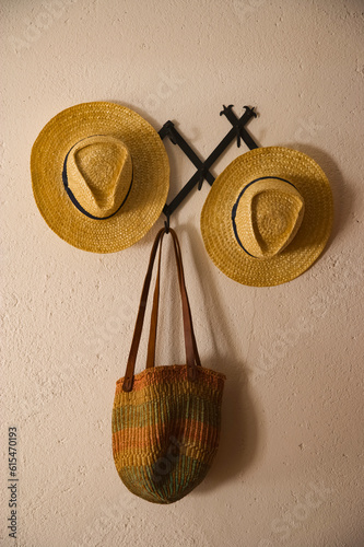 Two hats and a basket on a wall in a house in wine country; Portugal photo