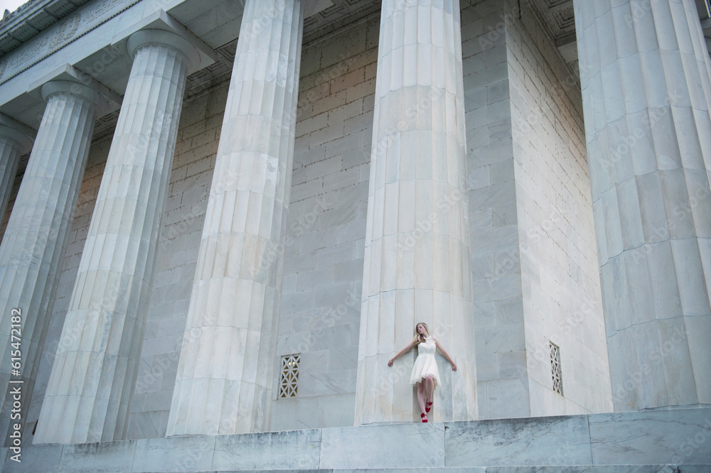 Teenage girl standing against a large column at the Lincoln Memorial in Washington DC, USA; Washington, District of Columbia, United States of America Teenage girl standing against a large column at the Lincoln Memorial in Washington DC, USA; Washington, District of Columbia, United States of America