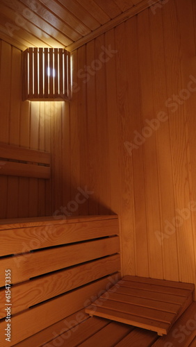 sauna room with wooden sitting groups surrounded by wood