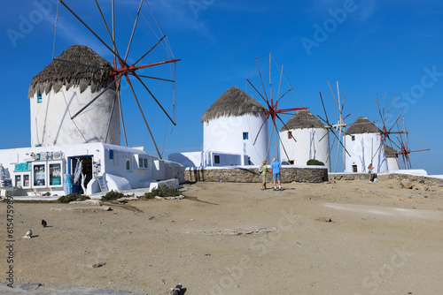 Old white traditional windmills of the famous Mykonos island, greece a summer sunny day