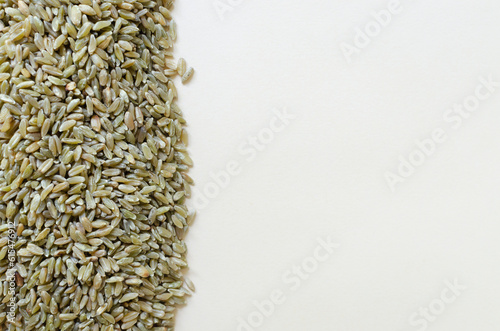 Raw freekeh or firik is the background on the left. Concept of healthy food. Vegan and vegetarian food. Horizontal orientation. Top view. Copy space. photo