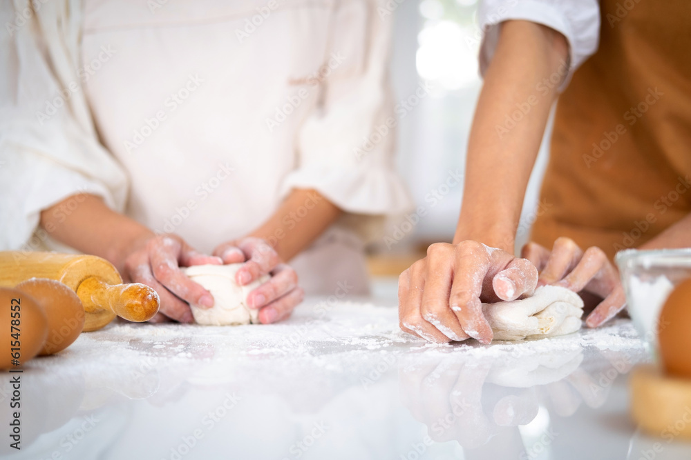 hands of the baker's female knead dough . Close up view of bakers are working. Homemade bread. Hands preparing dough on table for homemade pastry and bread. Cooking and baking at home concept. hands of the baker's female knead dough . Close up view of bakers are working. Homemade bread. Hands preparing dough on table for homemade pastry and bread. Cooking and baking at home concept.