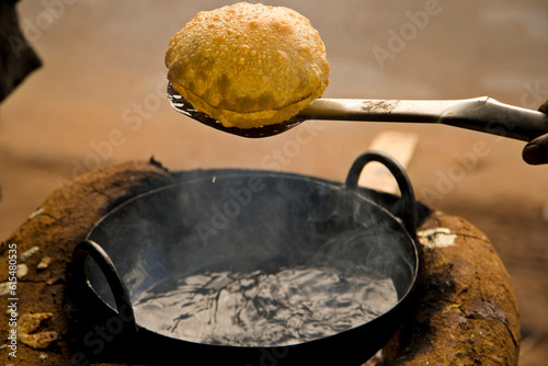 Fresh fried poori, or puri, on the streets of India; Karaikudi, Chettinad, India photo