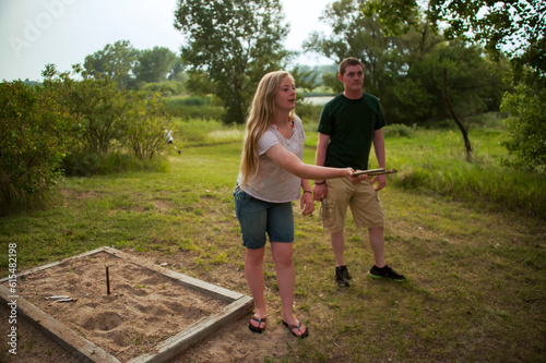 Brother and sister play horseshoes at an annual July 4th yard party; Bennet, Nebraska, United States of America photo