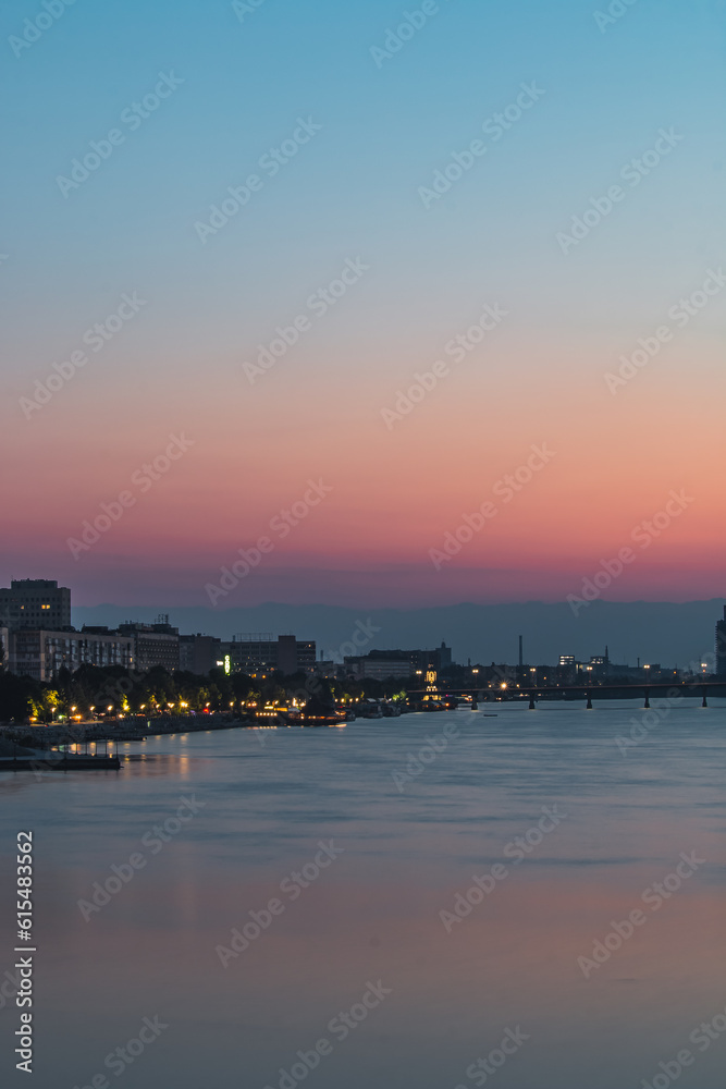 Вeautiful sunset near the river, turning into the night, view of the city of Dnipro