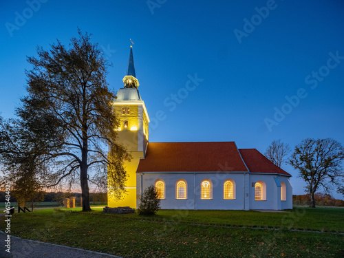 Illuminated Mežotne Lutheran Church in Latvia at night