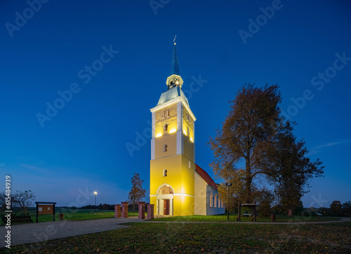 Illuminated Mežotne Lutheran Church in Latvia at night