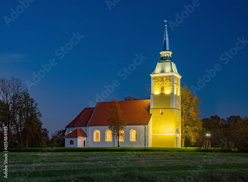 Illuminated Mežotne Lutheran Church in Latvia at night
