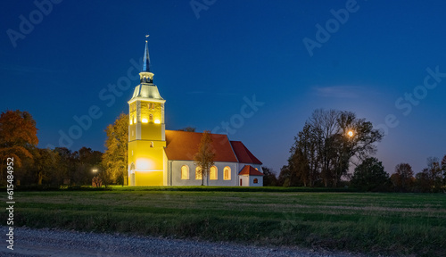 Illuminated Mežotne Lutheran Church in Latvia at night