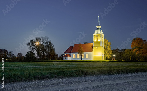 Illuminated Mežotne Lutheran Church in Latvia at night
