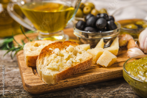 Italian ciabatta bread with olives, garlic, parmesan and rosemary on texture wooden background. Tasty food. Aperitif. Place for text. copy space. Delicacy. Bon appetit.