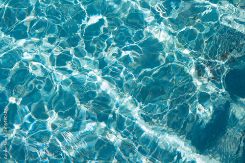 texture of the reflection of the sun on the turquoise water of the tropical sea. 
transparent water surface patterns background