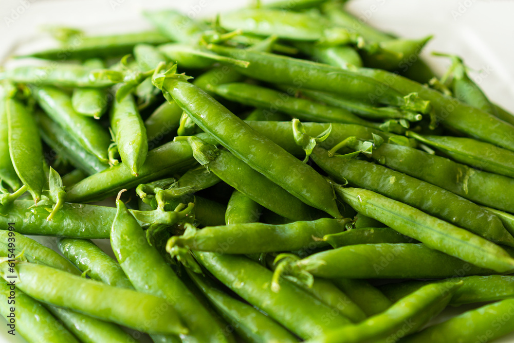 Fresh green peas on a wooden background. Summer crop of peas. Fresh green peas on a wooden background. Summer crop of peas.