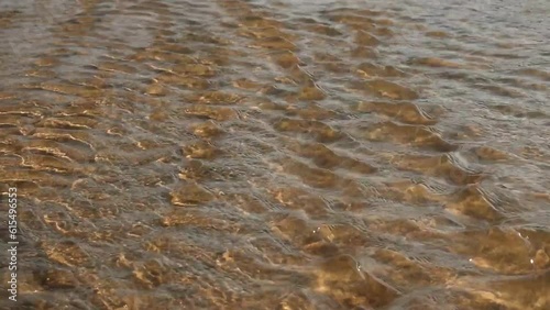 Clean pristine water flowing in a river channel symbolizing serenity, calmness, purity and nature