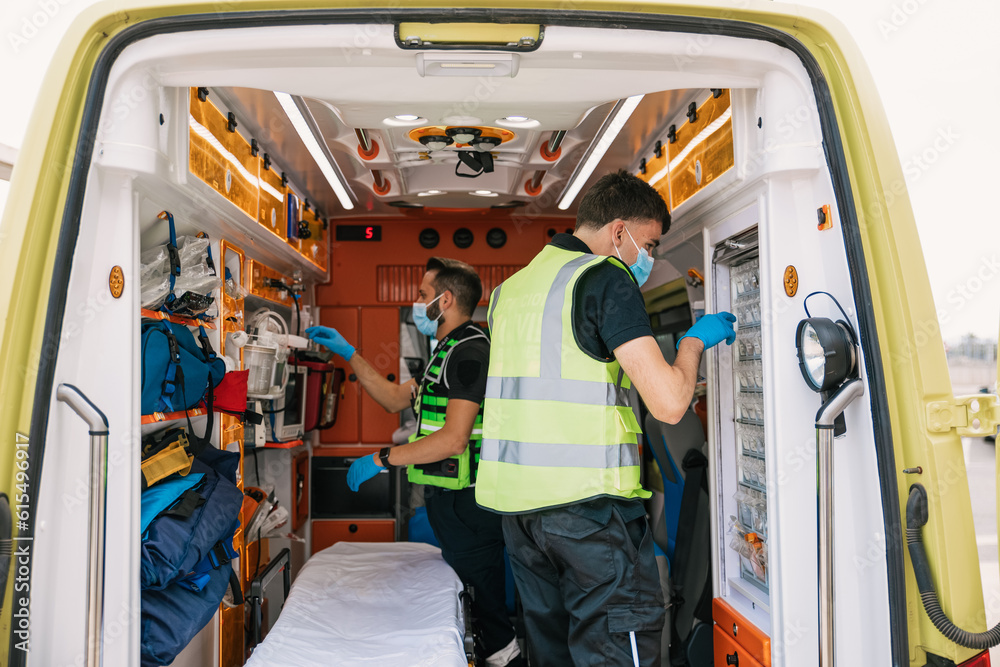 Paramedics preparing facility in automobile Paramedics preparing facility in automobile
