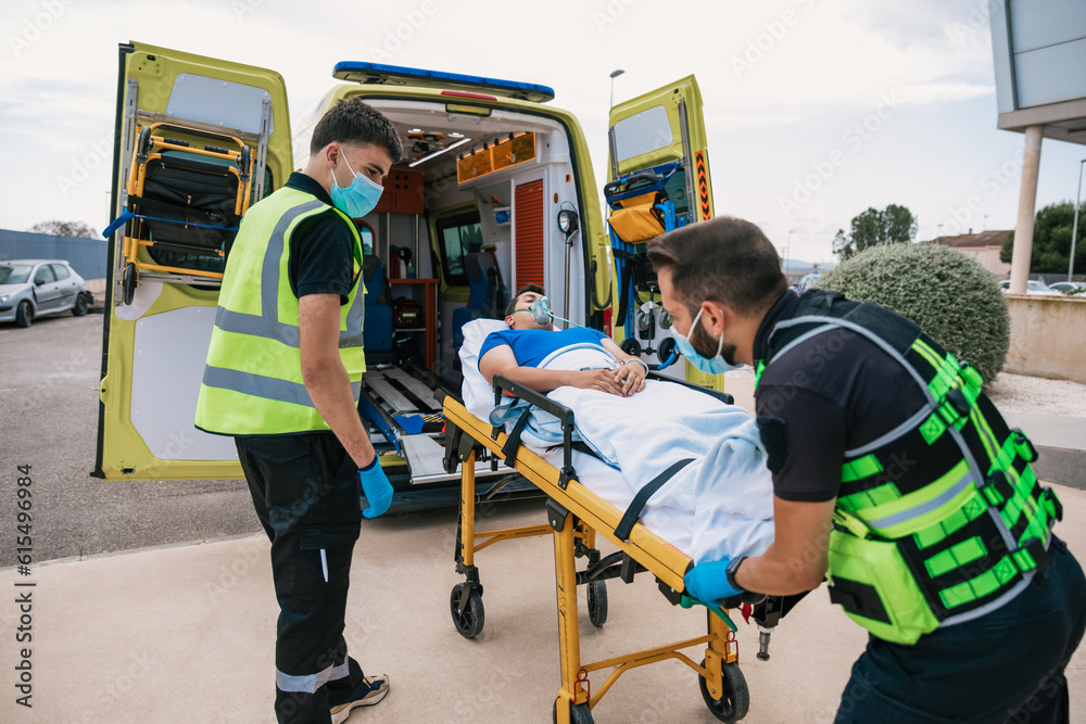 Emergency medical technicians taking patient away in automobile Emergency medical technicians taking patient away in automobile