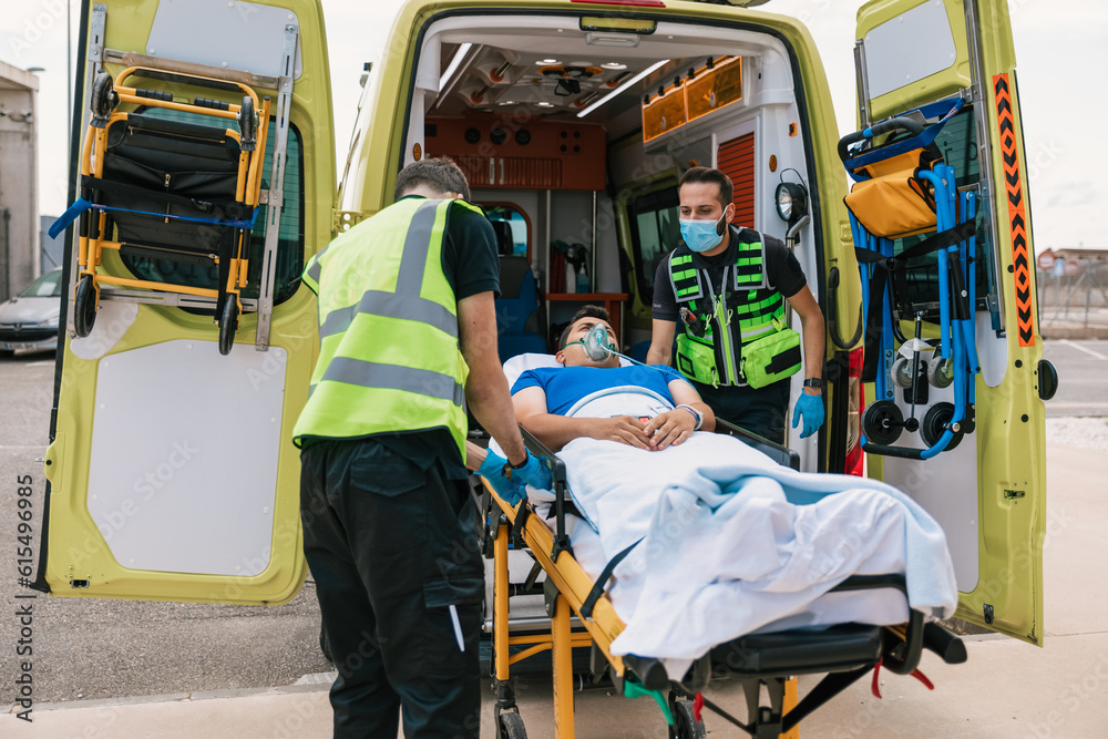 Emergency medical technicians taking patient away in automobile Emergency medical technicians taking patient away in automobile