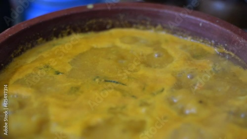 Indian spicy curry boiling in an earthen clay vessel. Suitable to showcase traditional cuisine recipe, restaurant business videos
