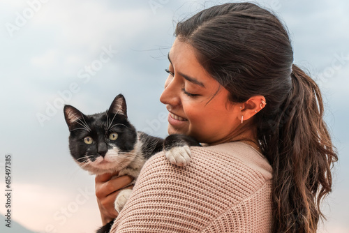 Woman embracing adorable stray cat photo