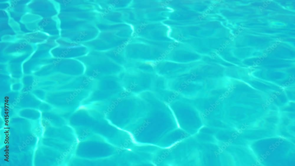 Surface of Pure Blue Turquoise Water Shimmers in the Sun Rays, Ocean Sea Swimming Pool Water Texture in Sunlight, Abstract Blue Green Water Background, Waves, Ripples. Surface of Pure Blue Turquoise Water Shimmers in the Sun Rays, Ocean Sea Swimming Pool Water Texture in Sunlight, Abstract Blue Green Water Background, Waves, Ripples.