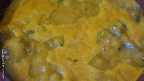 close up view of a fish / meat / vegetable curry getting boiled with various Indian spices and masalas added. Can be used for cooking, cuisine, kuruma and restaurant videos.