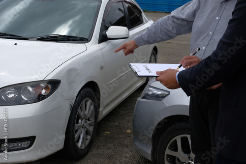 Loss Adjuster Insurance Agent Inspecting Damaged Car. © Charlie's
