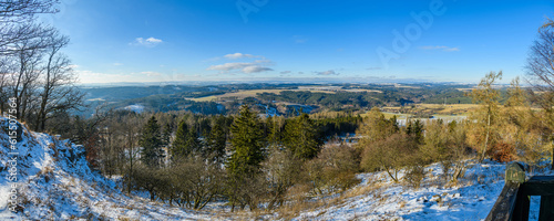 winter panorama from a hill into foresty landscape