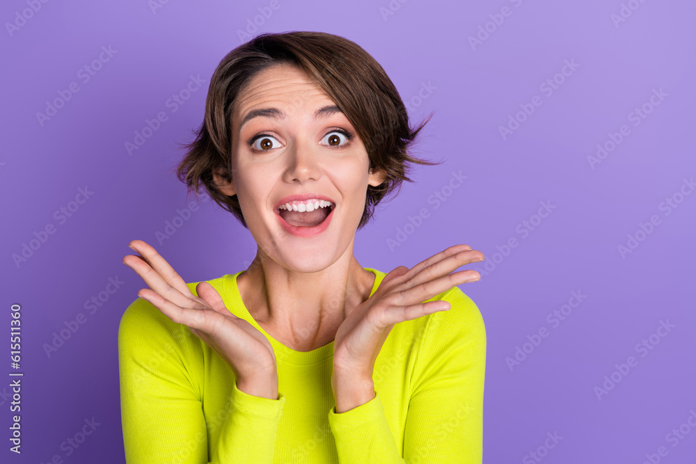 Photo of cheerful astonished person open mouth raise opened arms palms cant believe isolated on violet color background Photo of cheerful astonished person open mouth raise opened arms palms cant believe isolated on violet color background