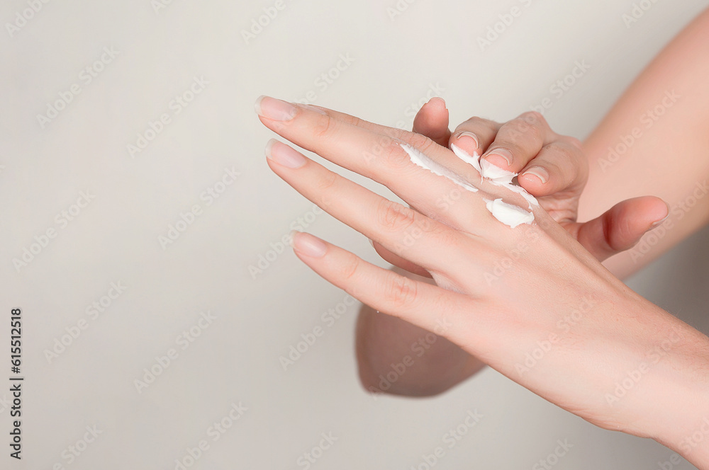 Unrecognizable crop woman applying cosmetic cream on hands Unrecognizable crop woman applying cosmetic cream on hands