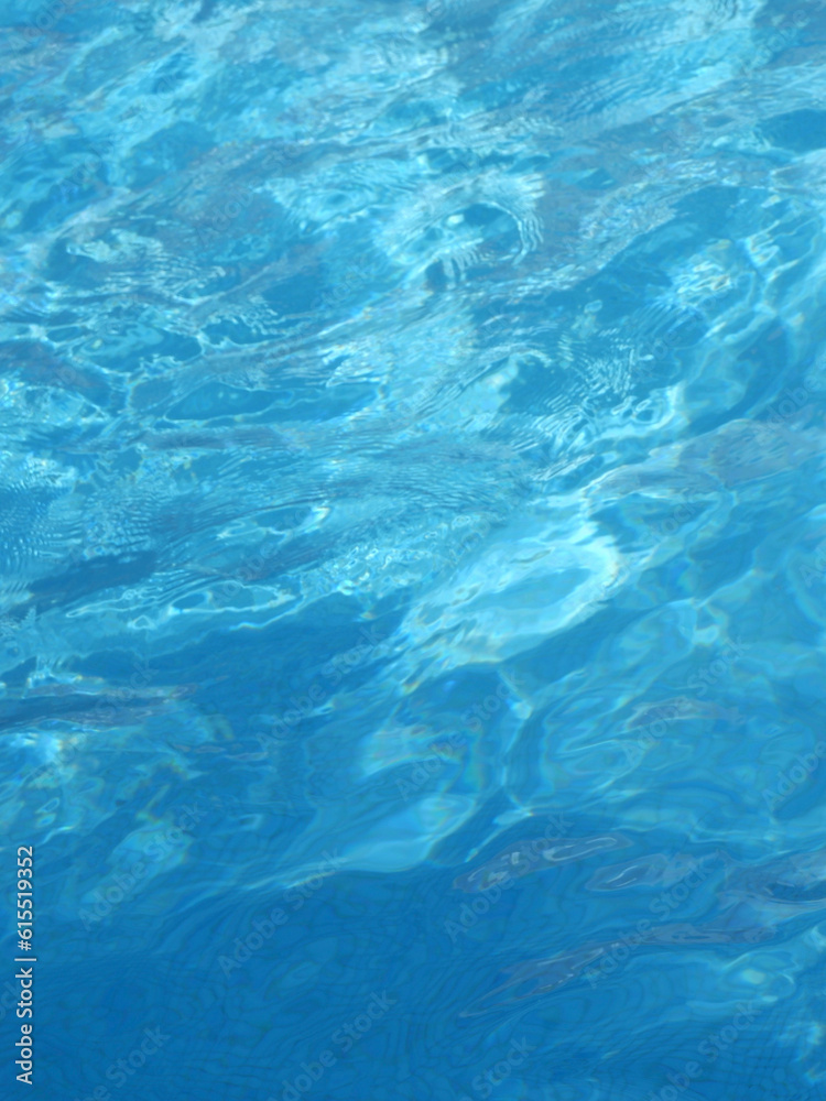 Surface of blue swimming pool at summertime. Backdrop and background of smooth clean water Surface of blue swimming pool at summertime. Backdrop and background of smooth clean water