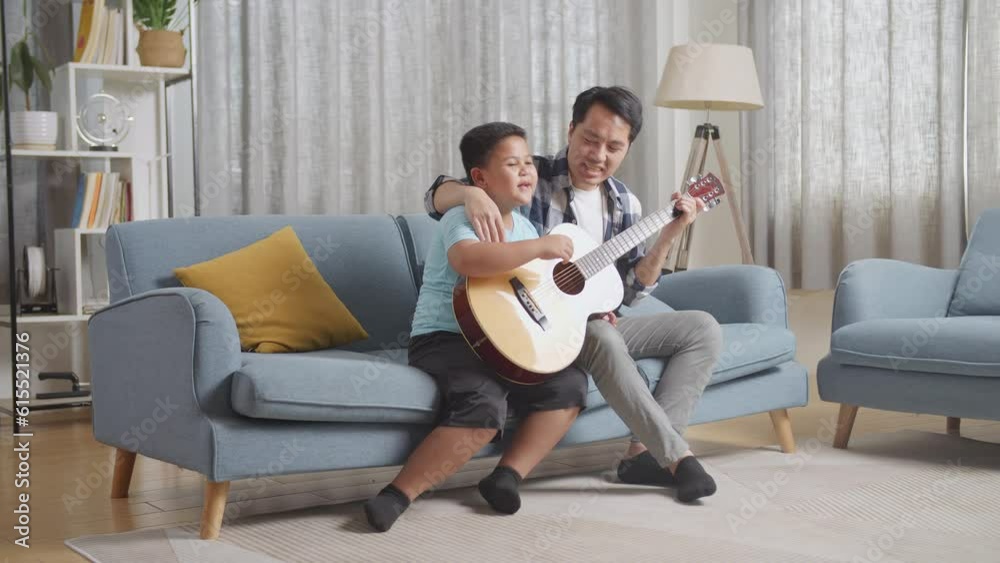Full Body Of Asian Father And Son Playing The Guitar And Singing Together On Sofa At Home
Full Body Of Asian Father And Son Playing The Guitar And Singing Together On Sofa At Home