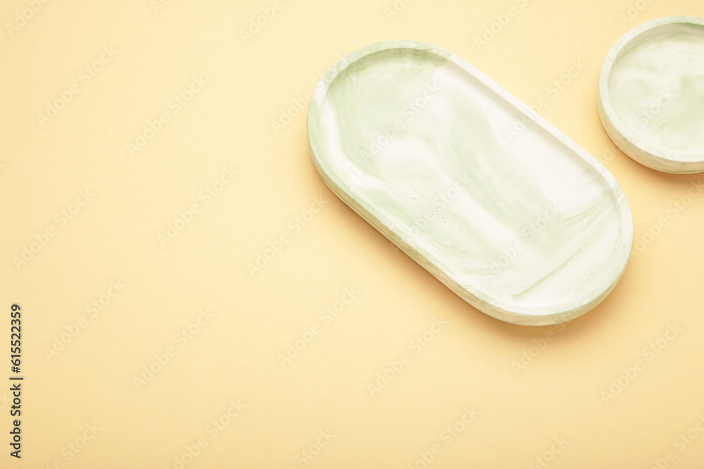 Mint plaster trays on beige background. Stands for candles or jewelry