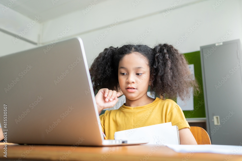 African American Elementary schoolgirl studying with laptop, E-Learning African American Elementary schoolgirl studying with laptop, E-Learning
