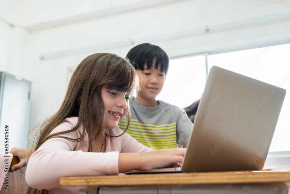 Diversity MultiEthnic Elementary school boy and girl using laptop. Diversity MultiEthnic Elementary school boy and girl using laptop.