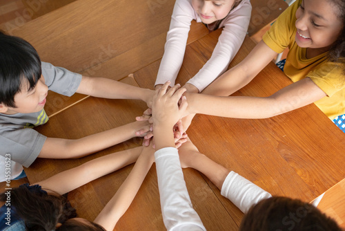 Top view Diversity MultiEthnic School pupils putting hands together