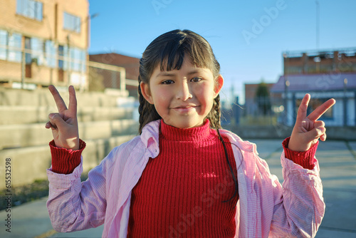 happy and smiling latina girl making peace signs