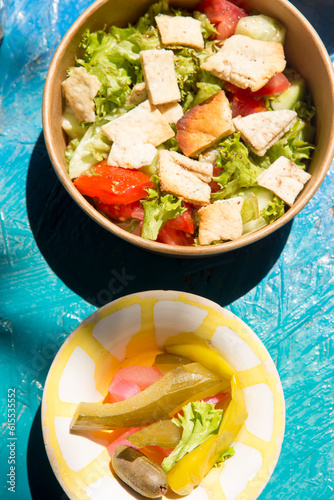 Summer salad with lettuce, tomato, cucumber and pitta with dressing and felafels photo