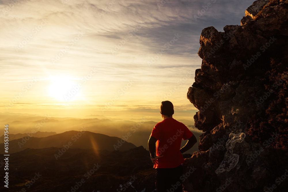 hiker on his back contemplating the sunset from a mountain peak. sport and adventure. hiking and trekking.