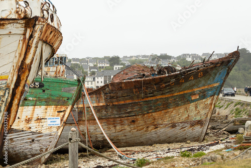Shipwrecks with colorful peeled paint in the ship graveyard of Camaret-sur-Mer, Finisterre, Brittany, France photo