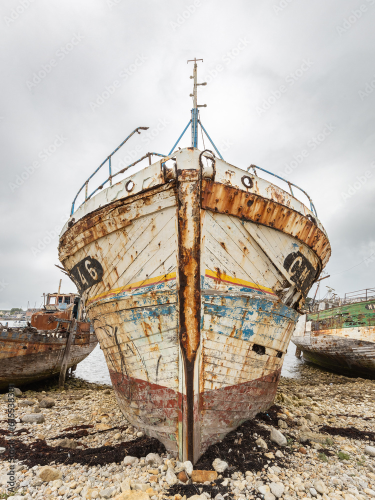 Shipwreck with colorful peeled paint in the ship graveyard of Camaret-sur-Mer, Finisterre, Brittany, France Shipwreck with colorful peeled paint in the ship graveyard of Camaret-sur-Mer, Finisterre, Brittany, France
