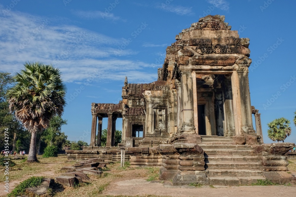 One ancient stone structure in the famous Khmer abandoned city of Angkor on a sunny day.