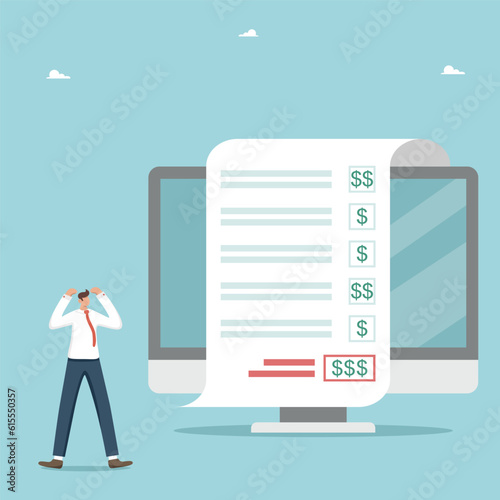 Monthly or quarterly payments on taxes or utility bills, interest payments on bank debt or mortgage, payment of a part of a personal loan or installment, shocked man near receipt from computer screen.