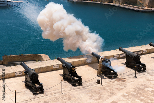Traditional firing of the cannon saluting battery at noon in Valletta, Malta.